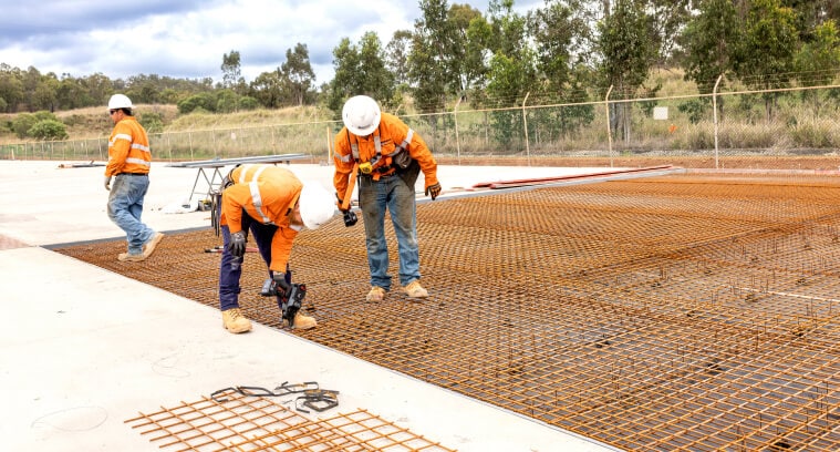 Workers installing concrete formwork