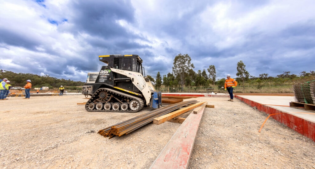 A forklift picking up rebar