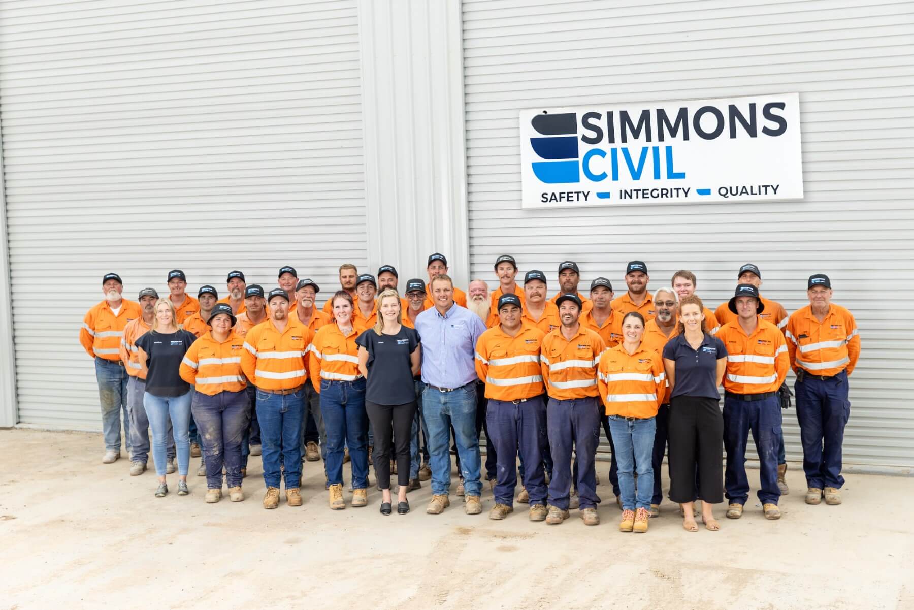 Simmons Civil team standing in front of shed