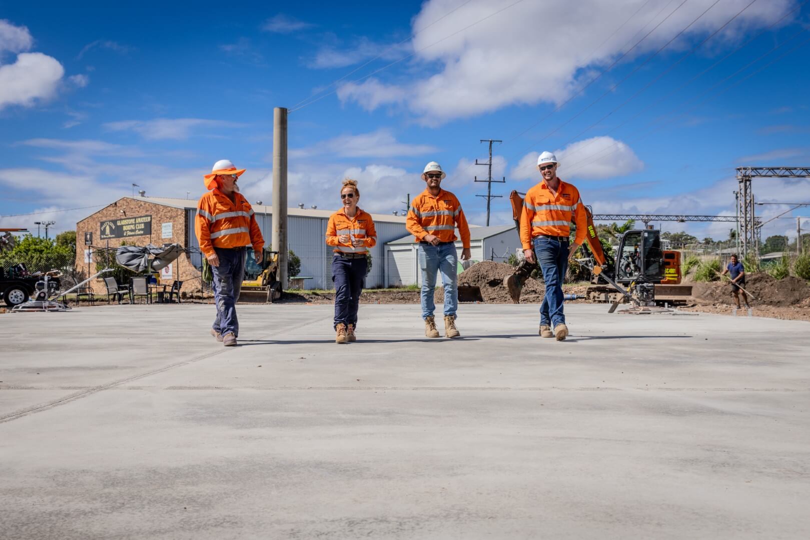 4 Simmons Civil workers walking together on new concrete slab